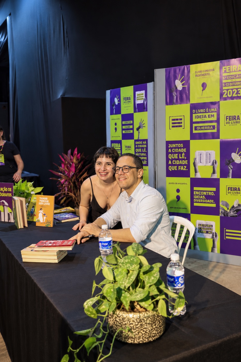 Luana sorrindo numa sessão de autógrafos da Feira do Livro